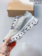 Side view of a light gray running shoe with a sculpted white sole