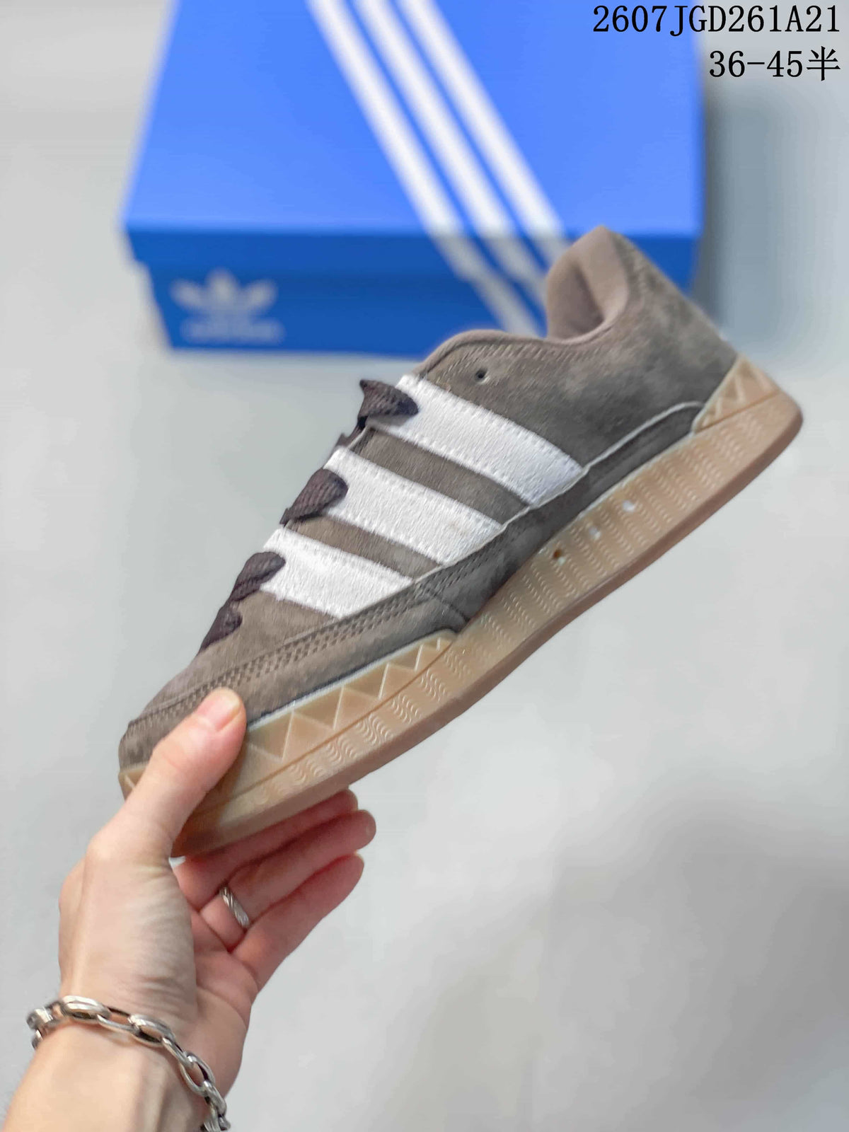 Side view of the low-top sneaker showing the brown upper, white three stripes, dark laces, and gum-colored sole.