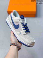 Angled side view of the white and blue low-top sneaker with blue laces and outsole.