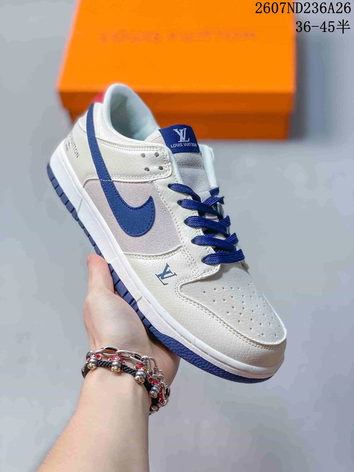 Angled side view of the white and blue low-top sneaker with blue laces and outsole.