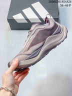 Side view of a mauve and gray low-top trail running shoe