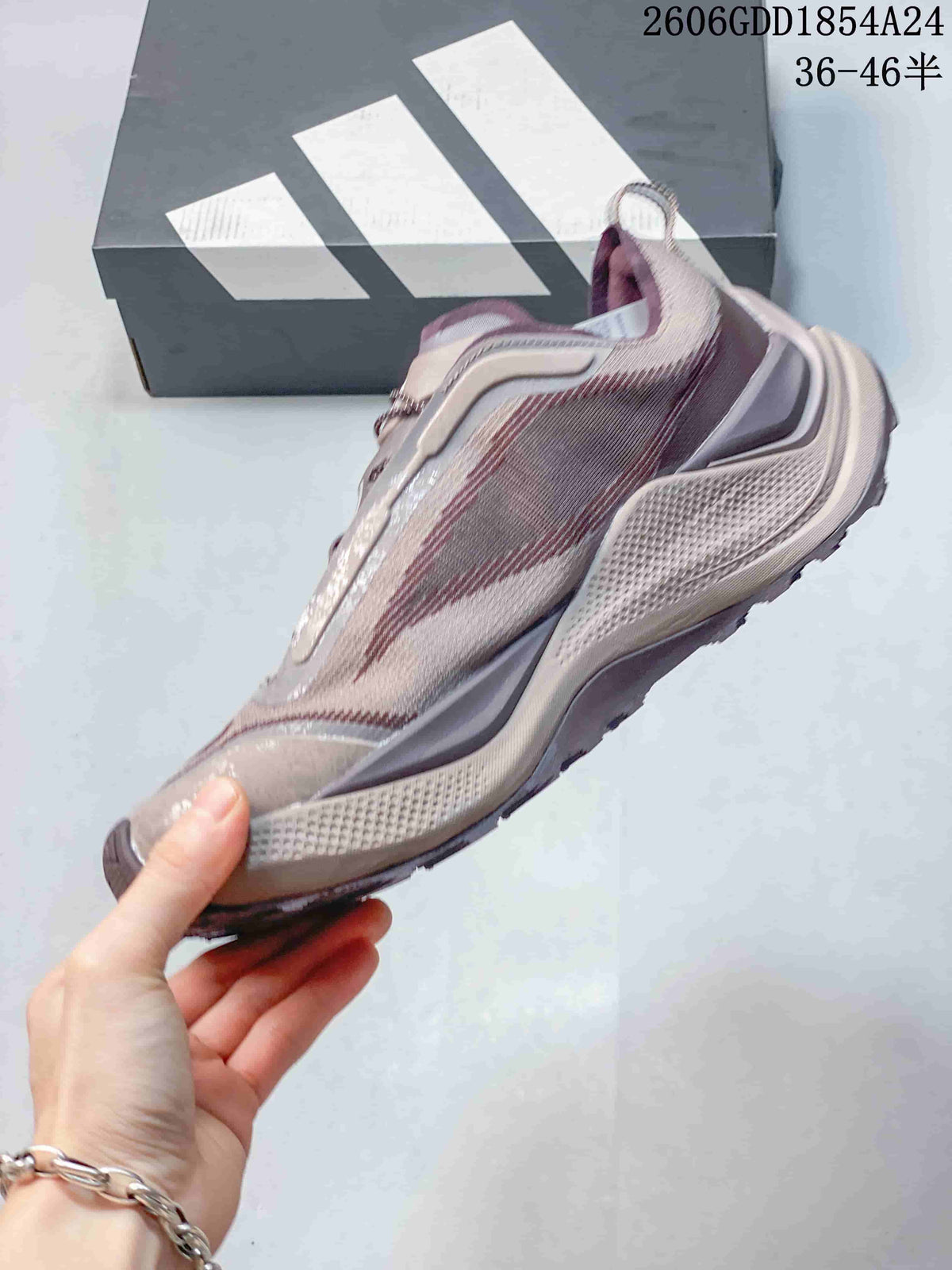 Side view of a mauve and gray low-top trail running shoe