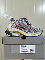 Side view of the metallic multicolor Runner sneaker displayed on its shoe box; the box label shows Runner product text and a C 37 size marking.
