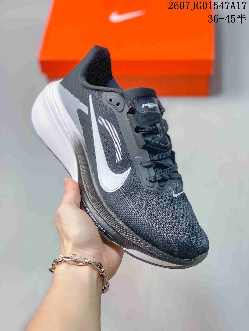 Black and dark gray Nike Air Zoom Pegasus 42 running shoe with a white Swoosh and white midsole.