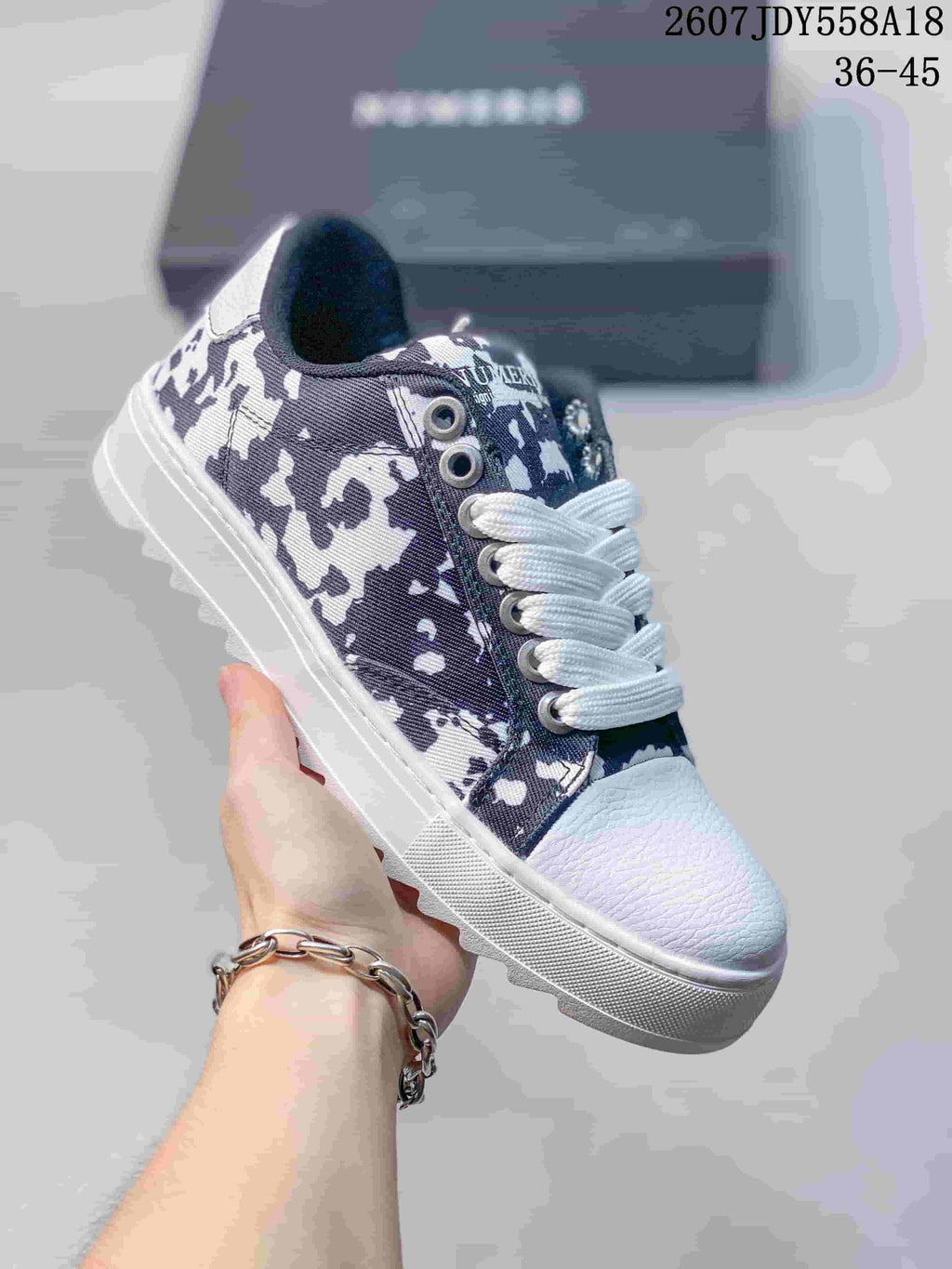 Blue-and-white NUMERIS low-top sneaker with an abstract camouflage-style print, white laces and a white toe cap; image shows size range 36-45.
