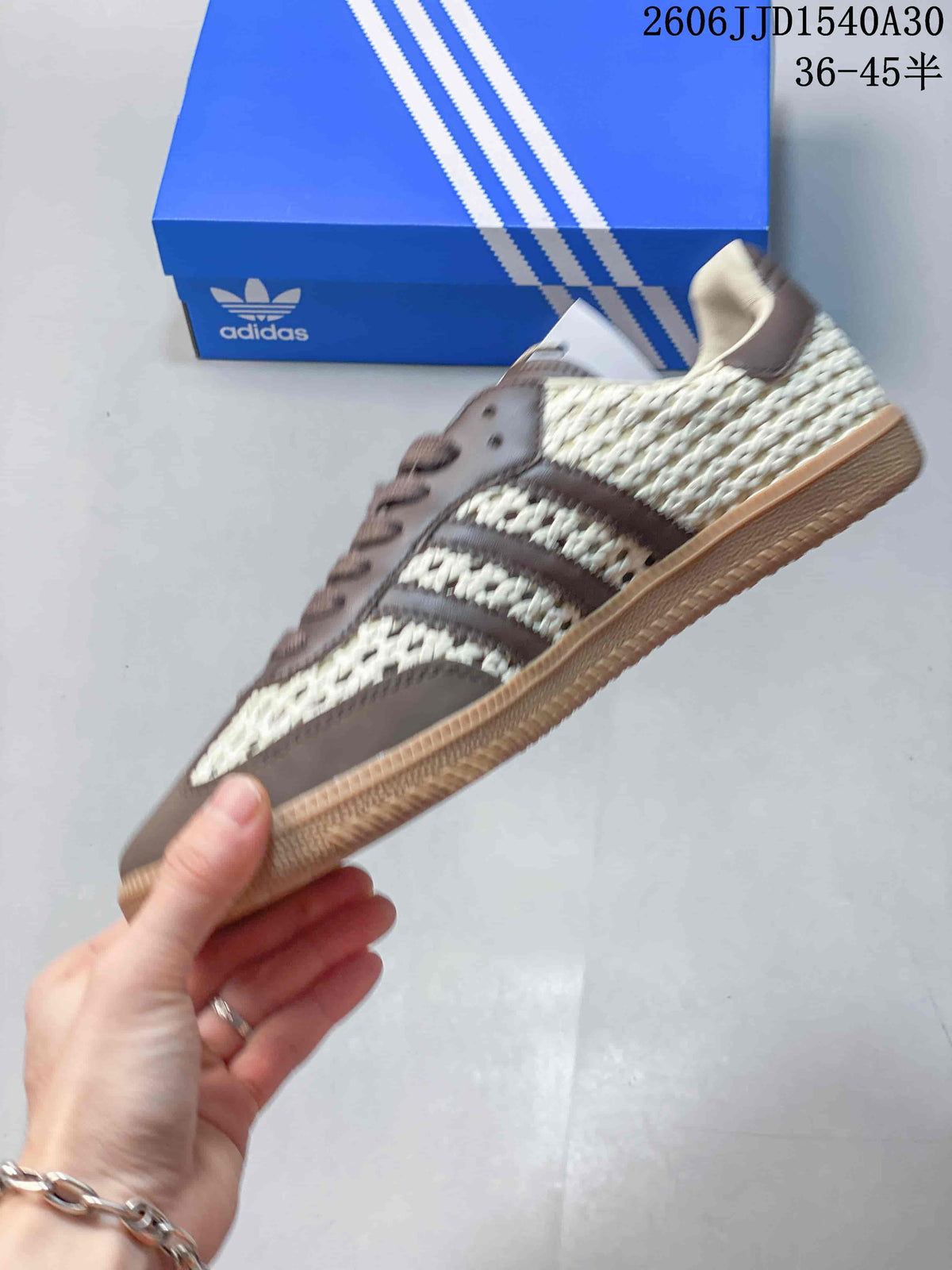 Side view of the sneaker with woven-look panels, three stripes, and gum-colored sole