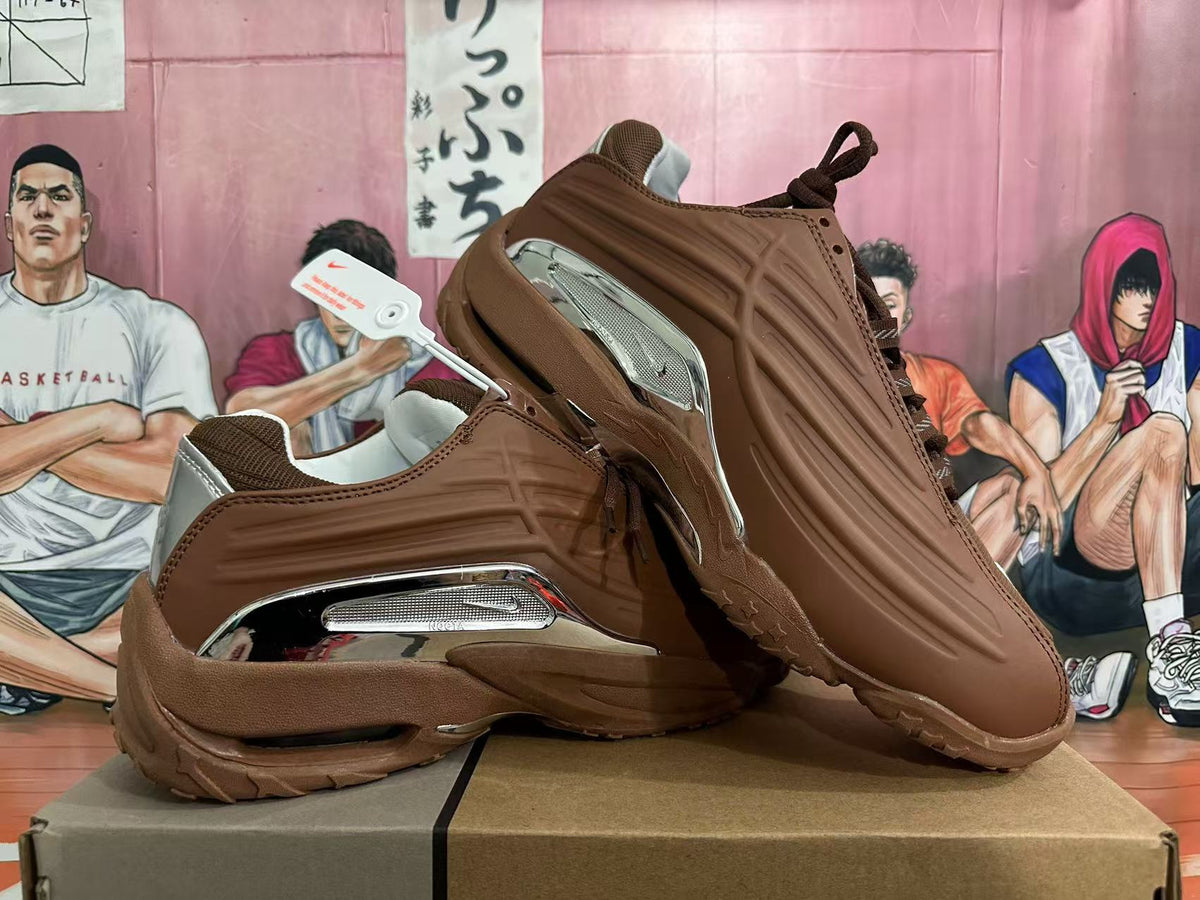 Pair of brown sneakers showing sculpted side panels and metallic silver accents