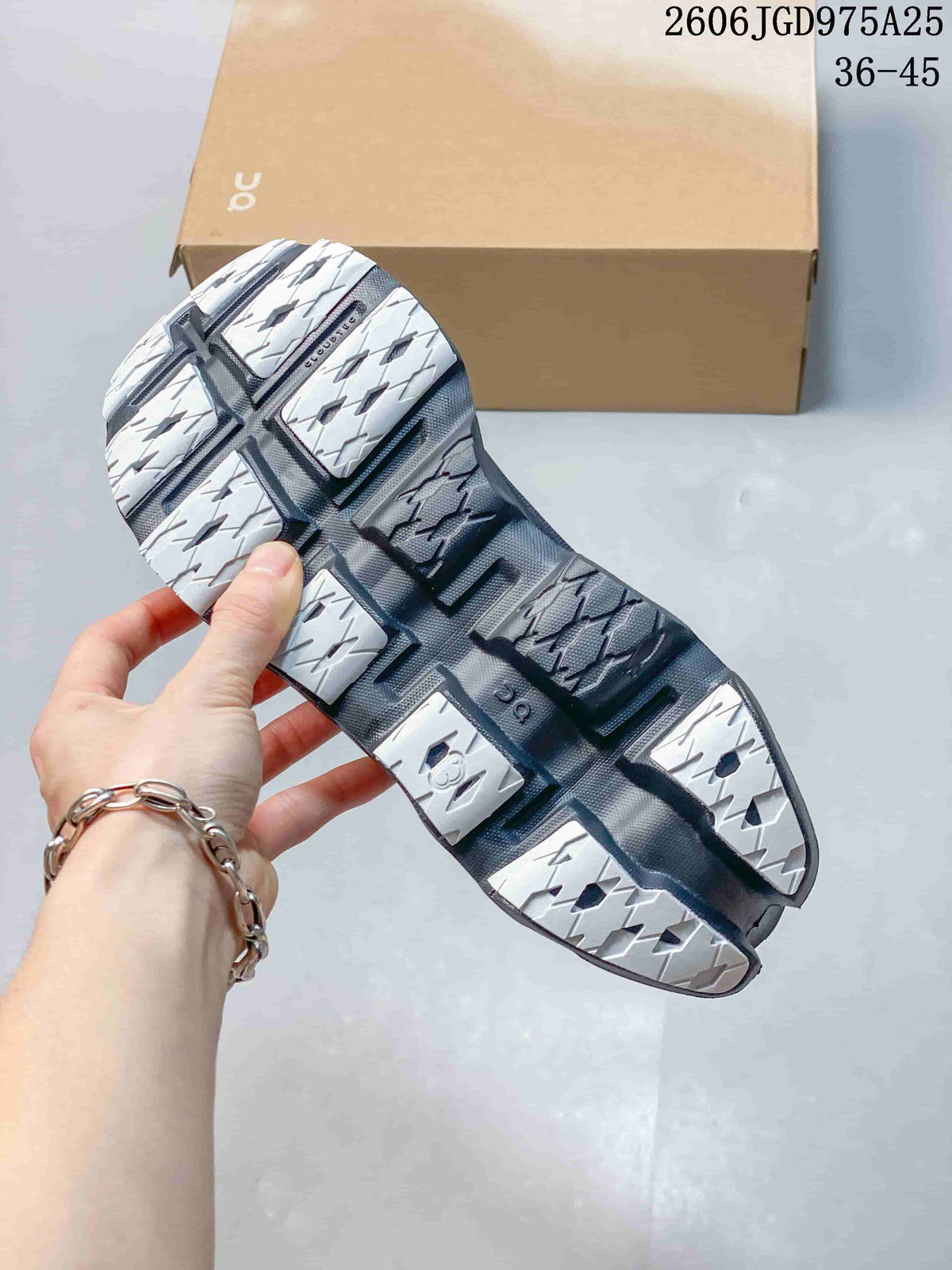 Close-up of the shoe outsole with segmented light and dark tread sections.