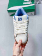 Top view of the white sneaker showing the lace-up front, blue tongue label, and padded blue collar.