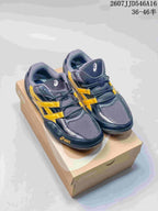 Pair of navy and yellow ASICS Hypersync sneakers shown from above on a shoebox.