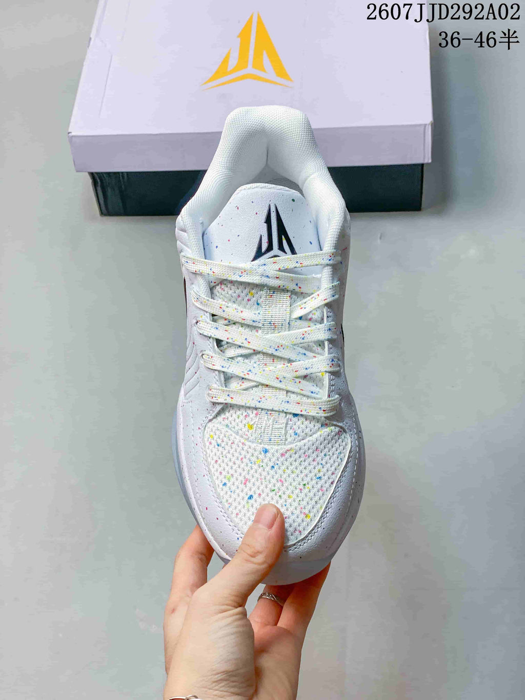 Top view of the basketball shoe showing the speckled mesh toe area, flat laces, and tongue branding.