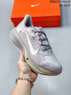 Angled side view of the silver-gray and white Nike Pegasus Plus shoe.