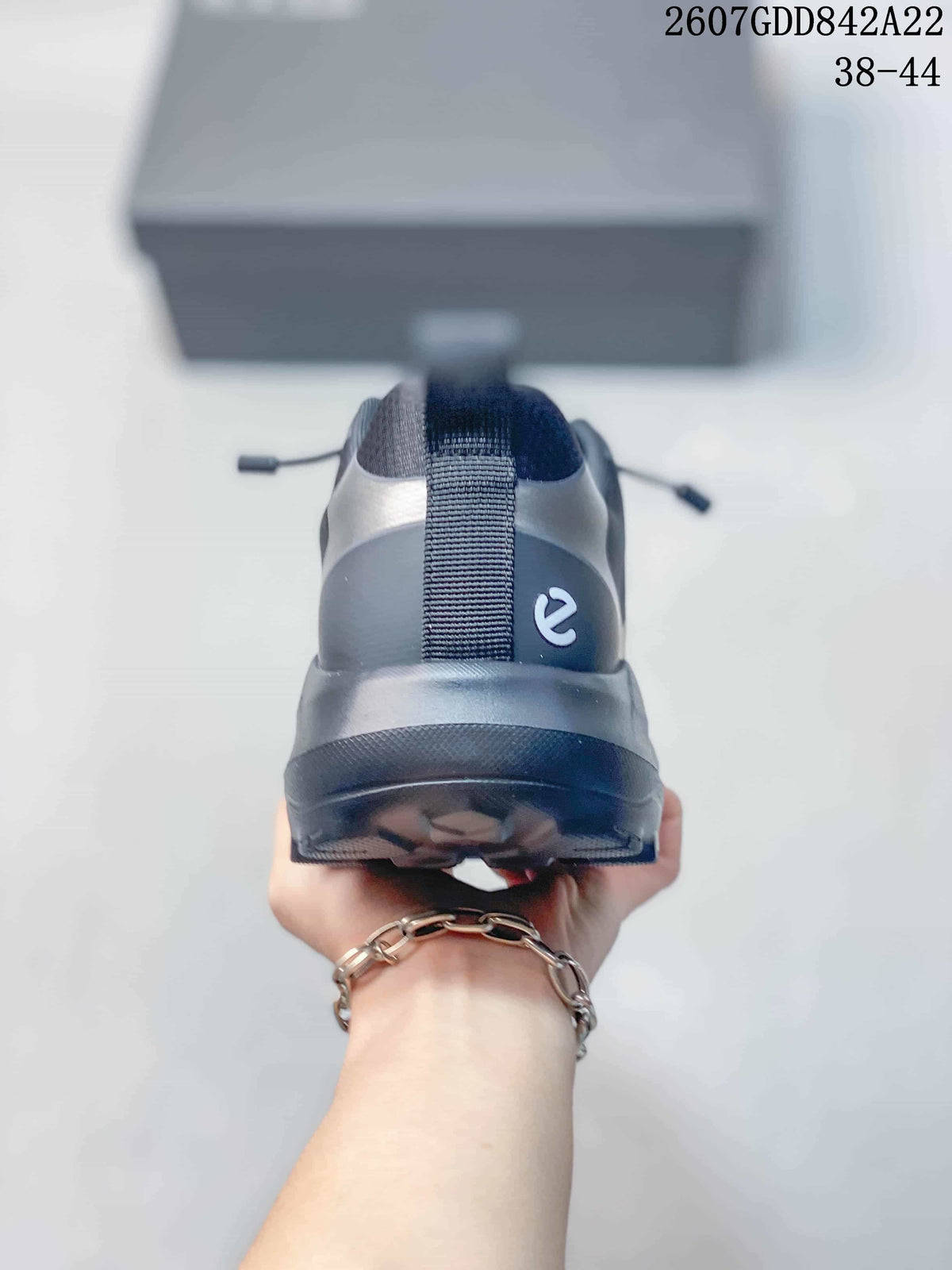 Rear view of the dark gray ECCO sneaker showing the heel pull tab, layered heel construction, and outsole profile.