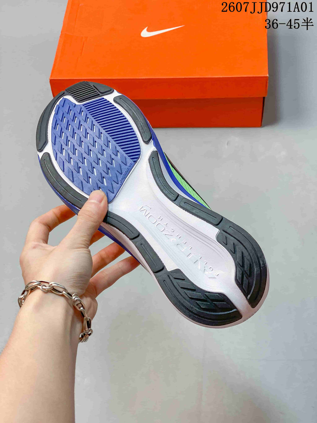 Outsole view of a Nike Pegasus 42 shoe, showing blue tread and dark rubber sections