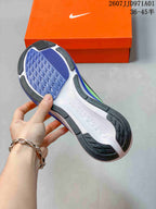 Outsole view of a Nike Pegasus 42 shoe, showing blue tread and dark rubber sections
