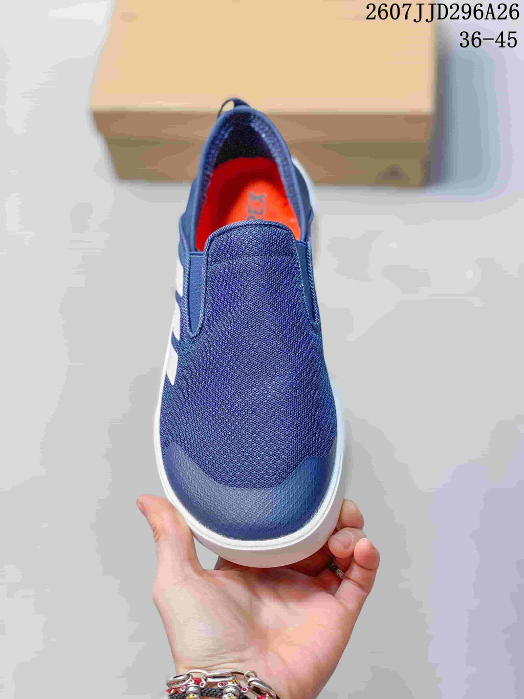Top view of the navy slip-on shoe showing the broad tongue and orange footbed.
