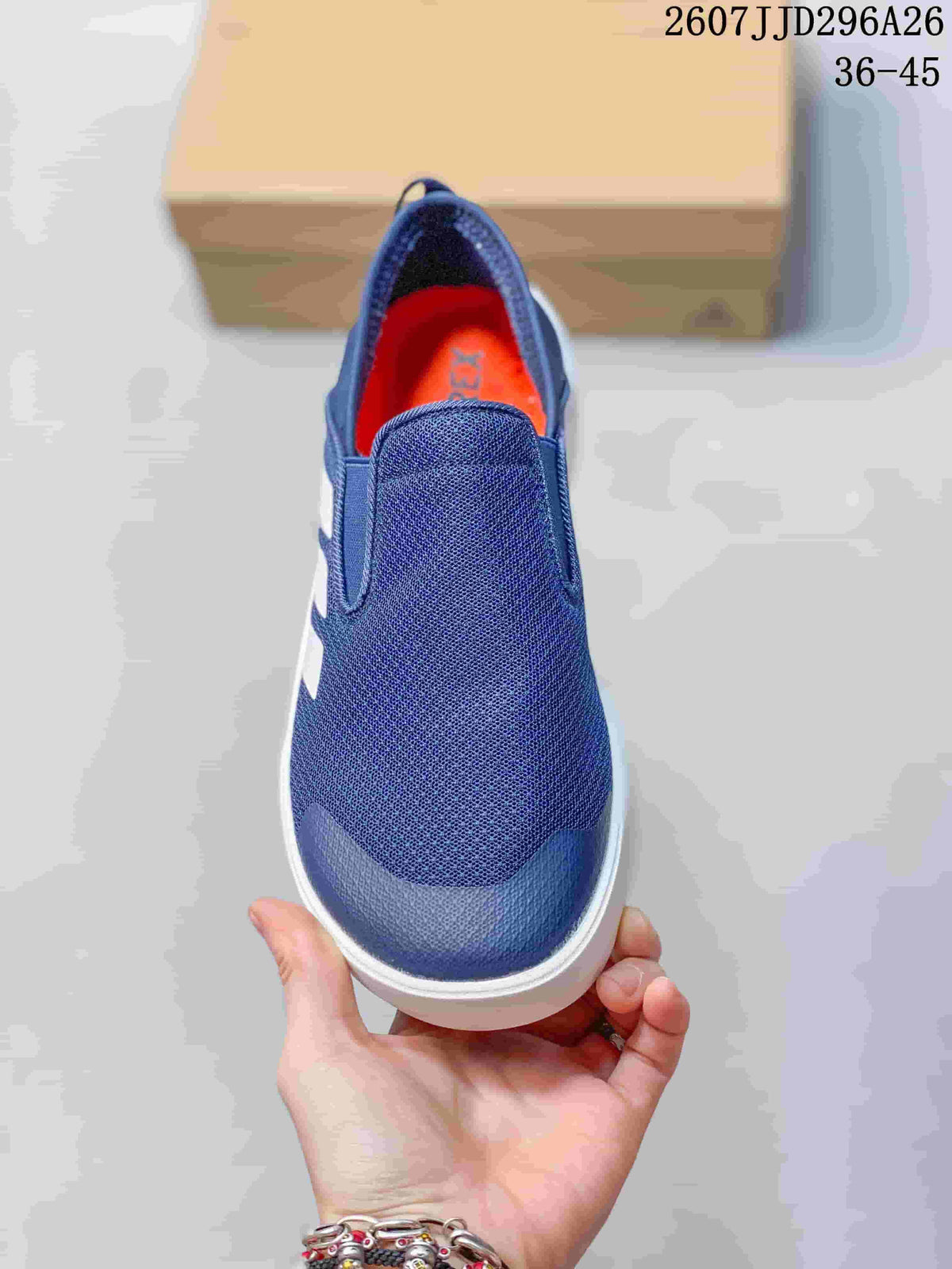 Top view of the navy slip-on shoe showing the broad tongue and orange footbed.