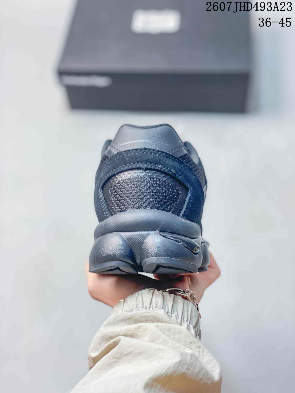 Rear view of the dark Onitsuka Tiger sneaker showing the padded heel and sculpted sole.