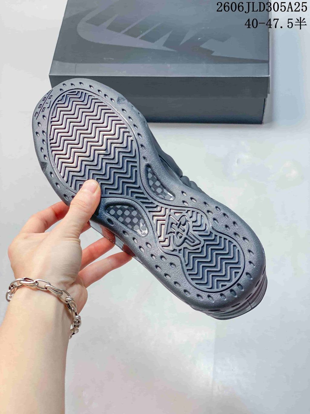Close-up of the gray shoe outsole with zigzag tread