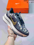 Dark navy and speckled white Nike Air Zoom Pegasus Premium sneaker with gold side Swoosh and visible cushioning-style midsole.