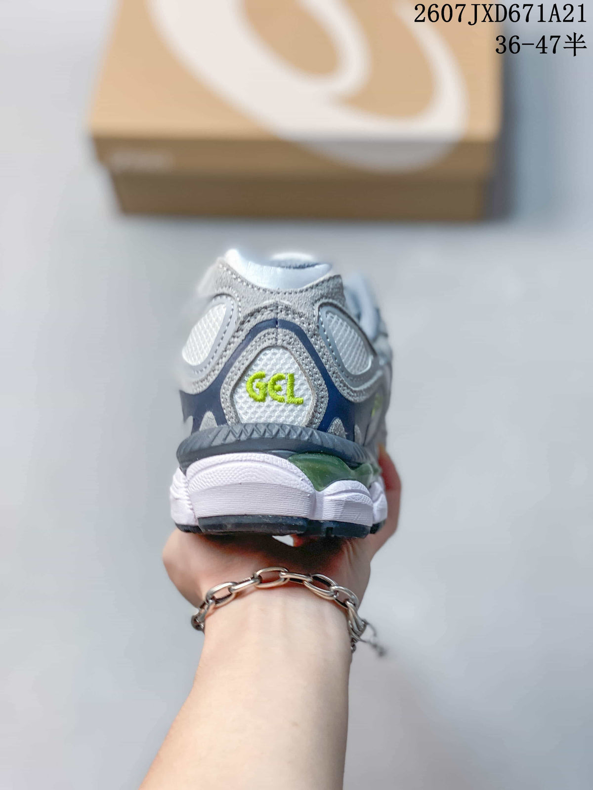 Rear view of the sneaker showing the padded heel, lime-green GEL detail and layered gray, white and dark outsole elements.