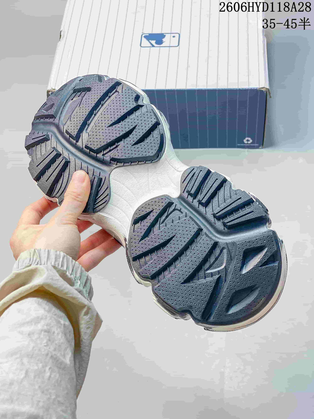 Underside of the sneaker showing its chunky patterned tread