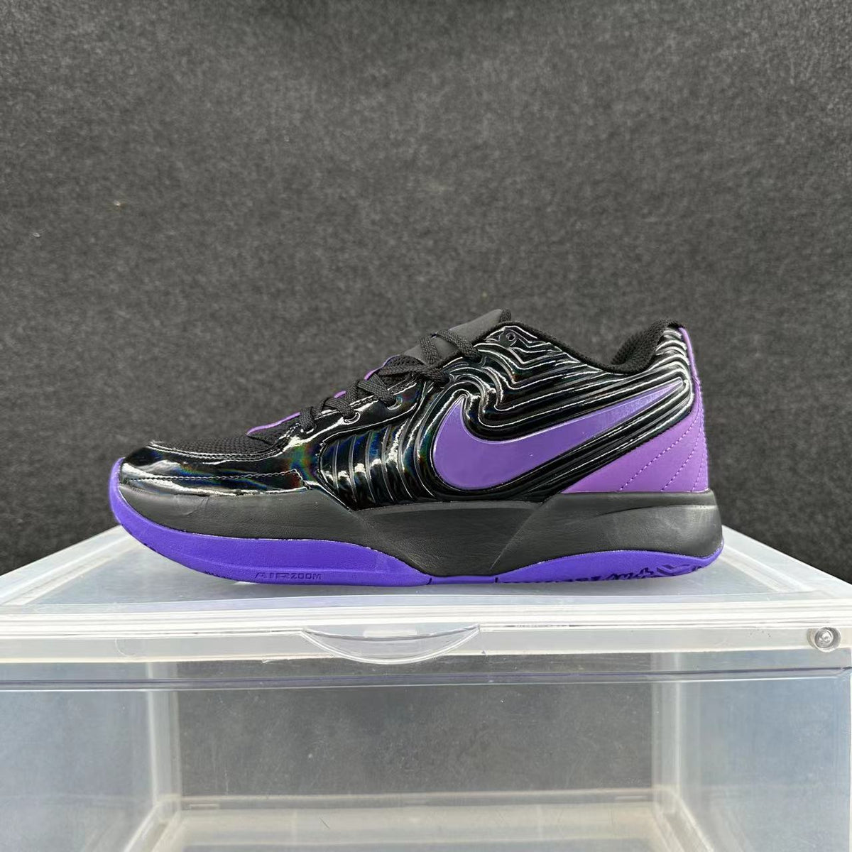 Side view of black Nike sneakers with a purple Swoosh and purple outsole.