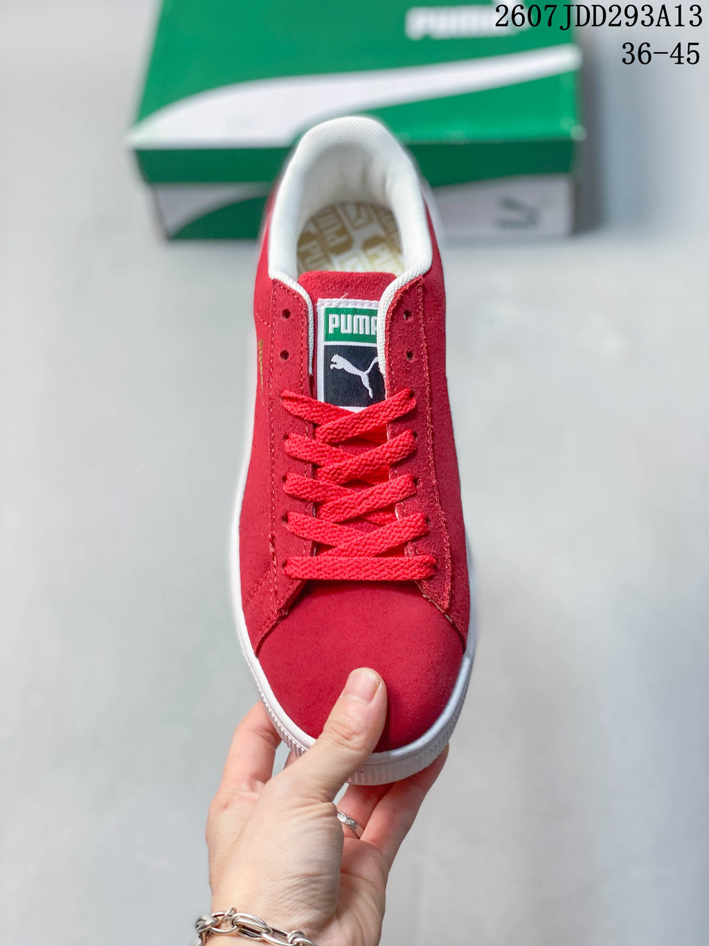 Top view of the red lace-up sneaker showing the padded white collar, tongue label, and white toe-edge trim.