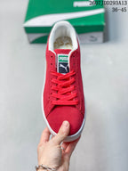 Top view of the red lace-up sneaker showing the padded white collar, tongue label, and white toe-edge trim.
