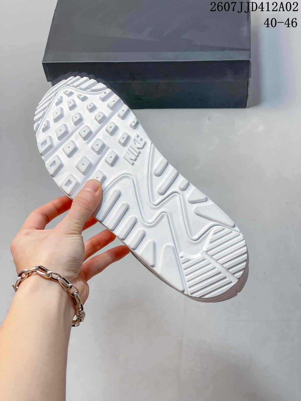 Outsole of a white sneaker showing patterned tread