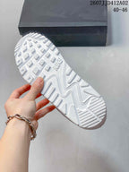 Outsole of a white sneaker showing patterned tread