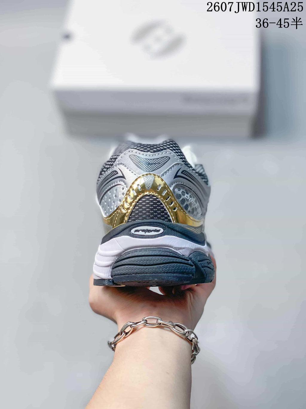 Rear view of the Saucony sneaker showing the layered heel design and gold accent.