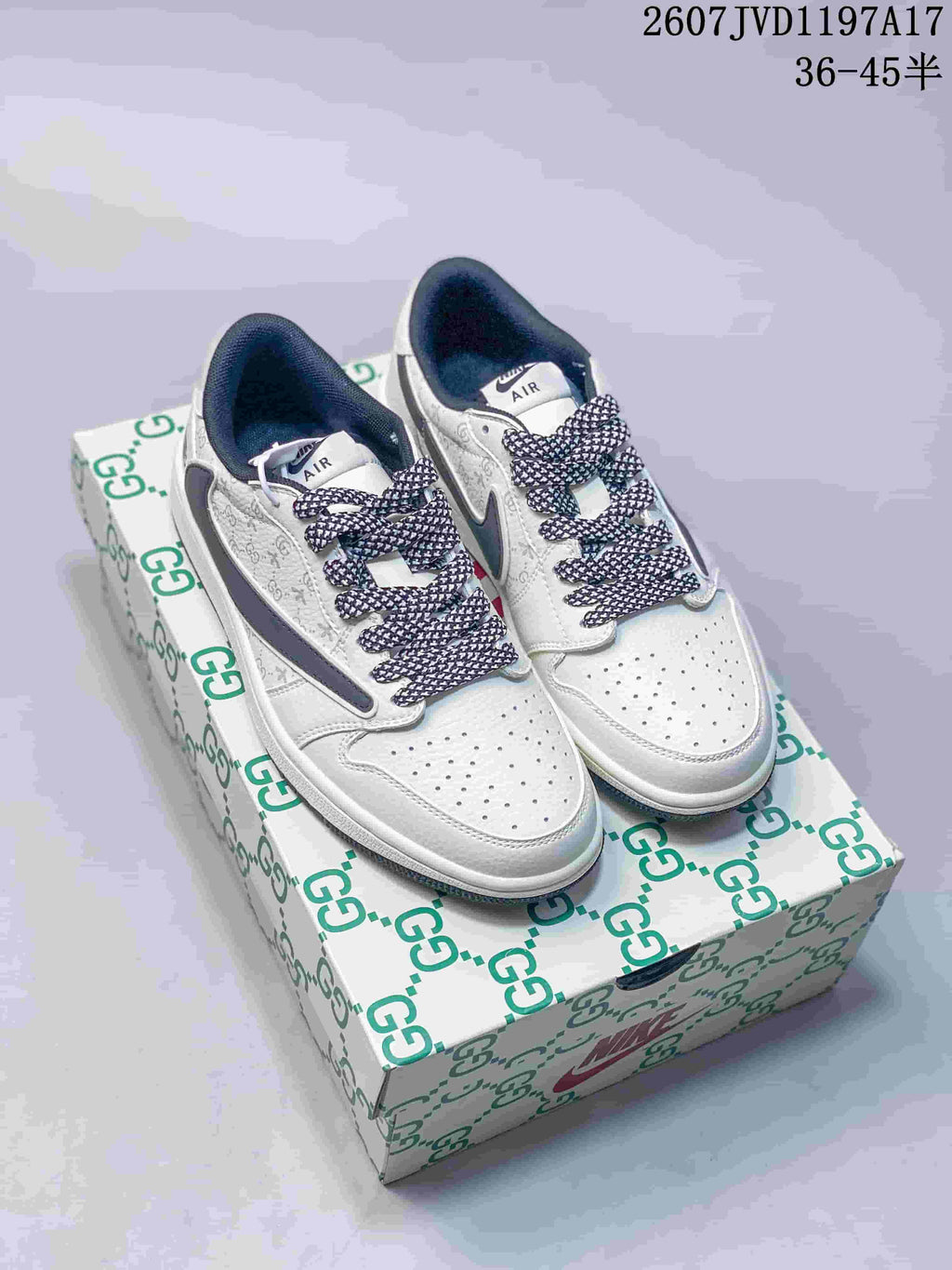Pair of white and grey low-top sneakers displayed on a patterned shoebox, with patterned laces and dark grey side Swoosh details.