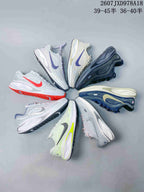 Several Nike Journey Run colorways arranged in a circular display, showing varied logos, uppers, and outsole accents.