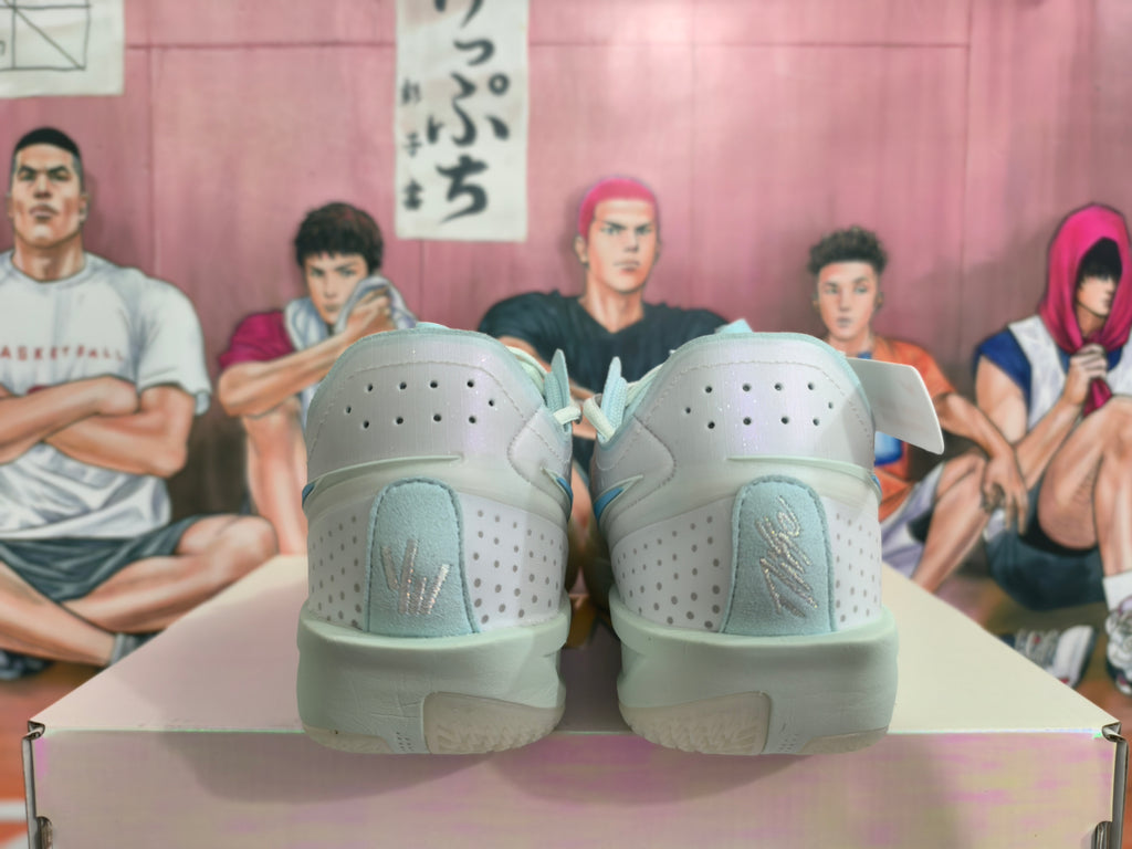 Rear view of light gray Nike basketball shoes with perforated heel panels and pale blue details