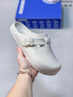 White closed-toe buckle sandal shown from an angled front view.