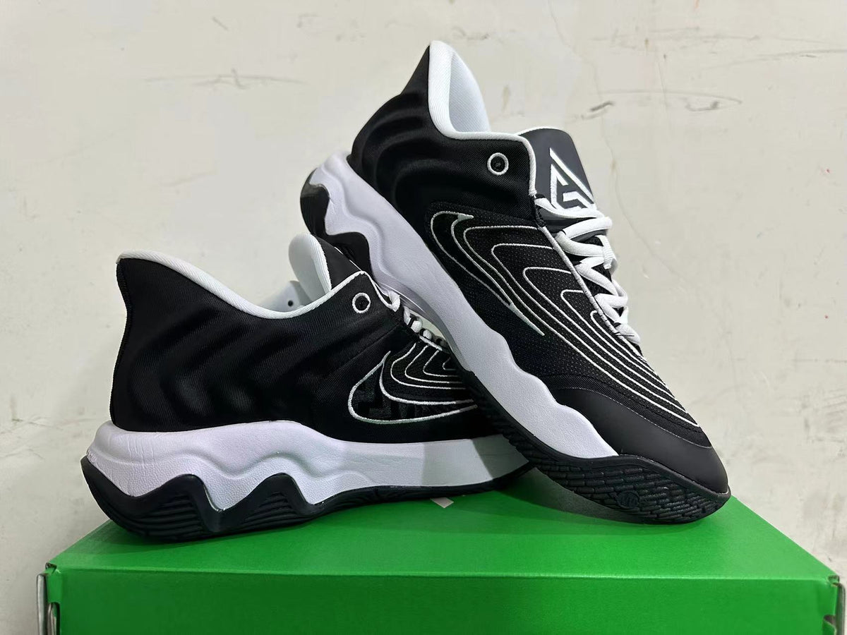 Pair of black and white Nike sneakers shown at an angle