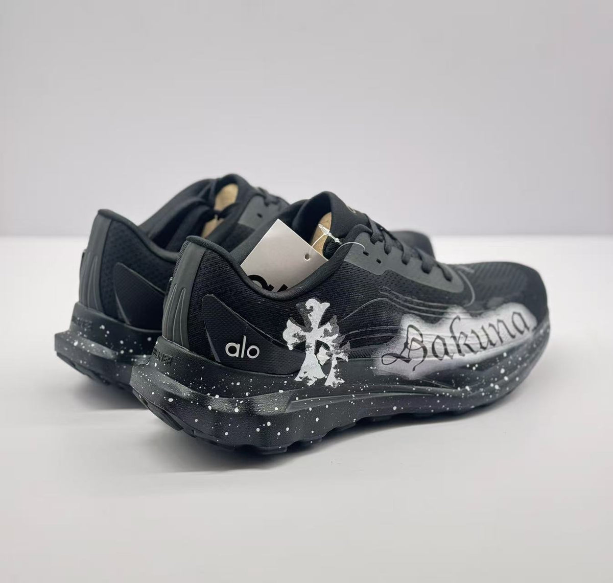 Rear angled view showing heel structure, alo branding and white speckle detailing.
