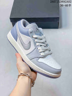 Angled view of the sneaker showing its white and blue-gray panels and side Swoosh.