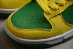 Close-up of the perforated green toe box, yellow trim, stitching, and white midsole.