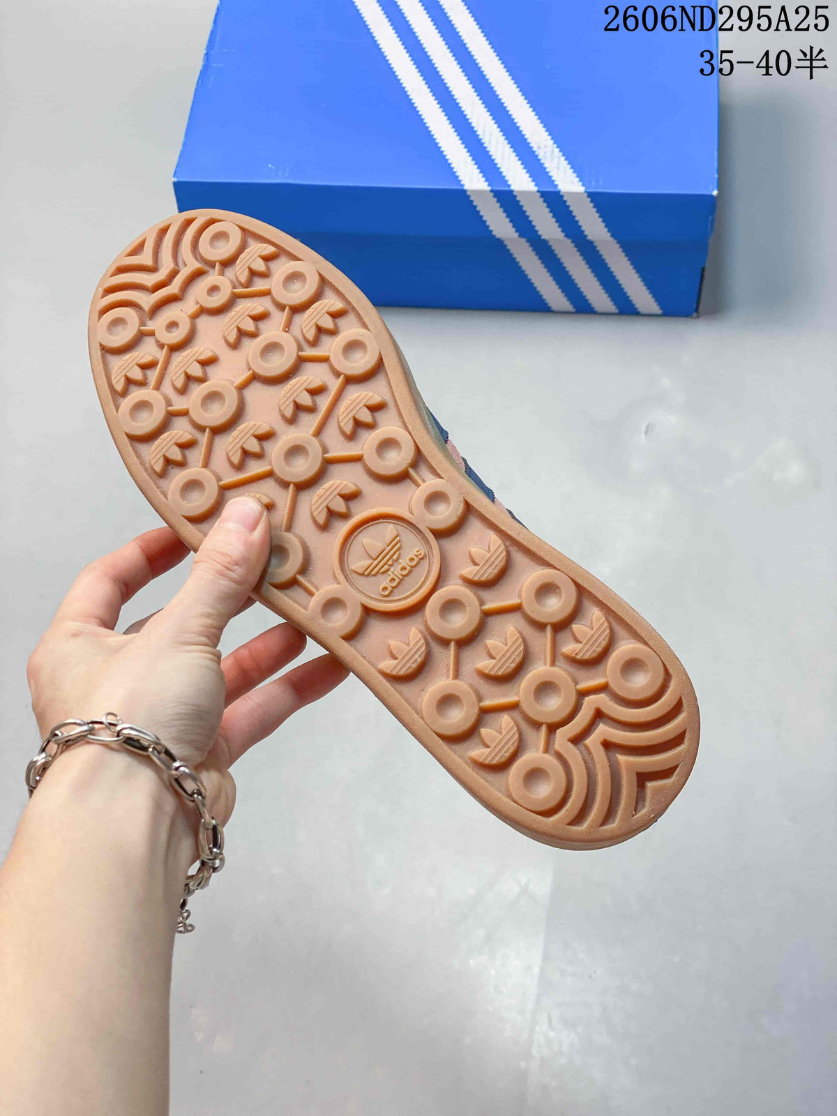 Close view of the gum-colored outsole showing its circular and trefoil-inspired tread pattern.