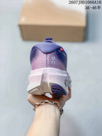 Rear view of one purple sneaker showing the padded heel collar, white midsole, and purple outsole section.