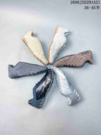 Multiple adidas Ghost Sprint colorways arranged in a circular display, including cream, white, brown, gray, navy and silver.