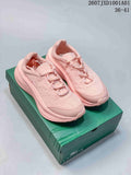 Pair of pink Lacoste lace-up sneakers displayed on a green shoe box
