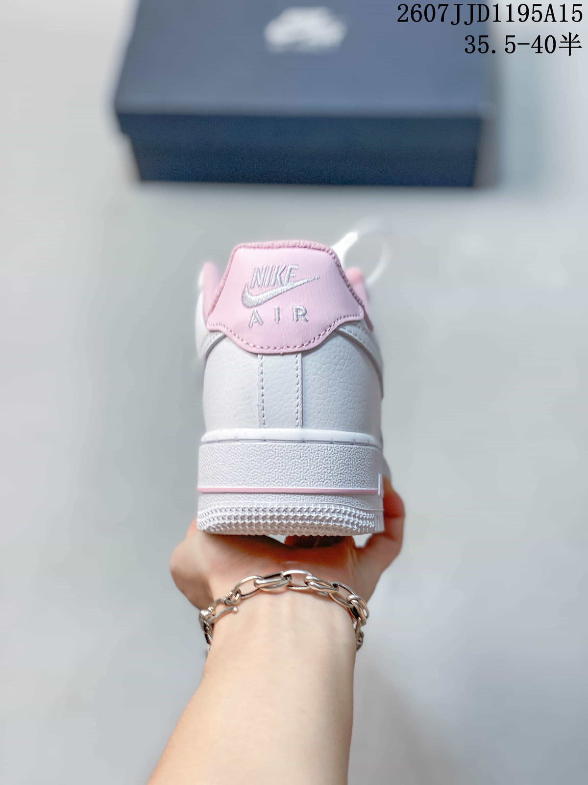 Rear view of a white sneaker showing pink heel-tab detailing and Nike Air branding.
