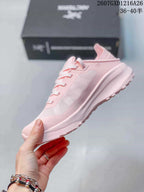 Side view of a pink Arc'teryx Sylan shoe showing the mesh-style upper, side overlay, lace system, and lugged outsole.