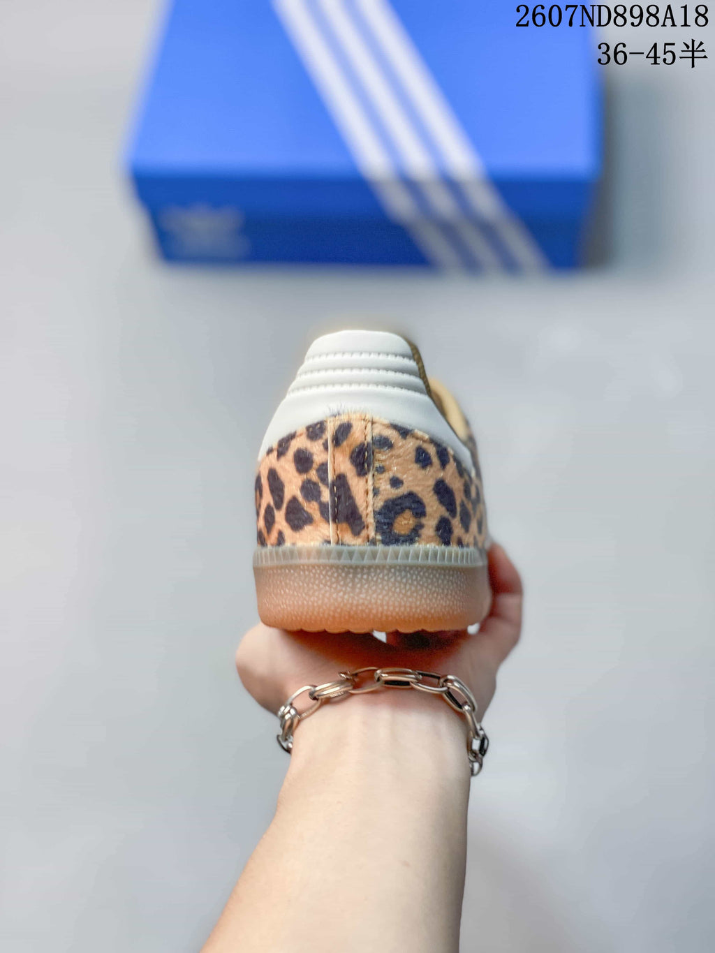 Rear view showing the leopard-print heel, white heel panel, and gum-colored outsole.