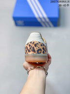 Rear view showing the leopard-print heel, white heel panel, and gum-colored outsole.