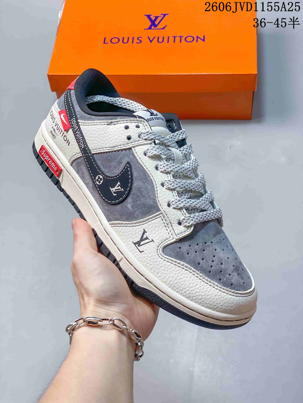 Close-up of a gray and white low-top sneaker with layered panels and patterned laces