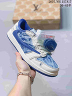 Blue denim-inspired low-top sneaker with white panels, blue overlays, and Louis Vuitton-style monogram details, shown with a branded box and spare laces.